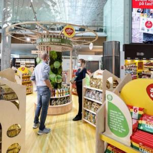 Mondelez Zero Waste activation at Oslo Airport featuring man and woman in front of snack displays