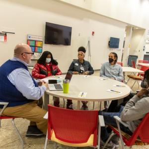 Whirlpool mentors and Benton Harbor High School students seated at a round table