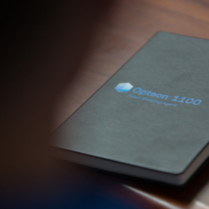 a black book with a logo for Opteon 1100 on the cover