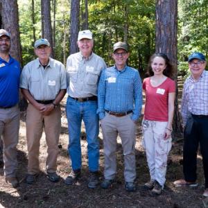 6 people standing in a forest
