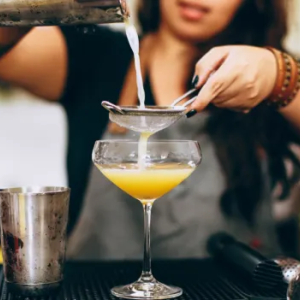 Person mixing a cocktail