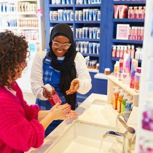  Bath & Body Work employee helping a customer