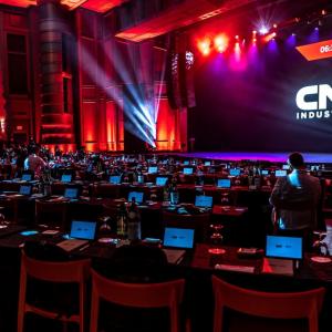 people sitting in auditorium with individual computers