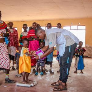 Rashei's weight is checked at the Action Against Hunger clinic. 