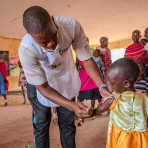 Rashei's MUAC measurement is taken at the Action Against Hunger outreach clinic. 