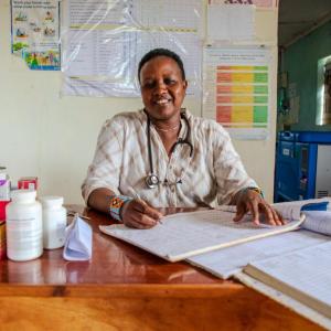 Emily sits at her desk in the health center. 