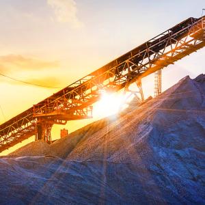 Mining equipment with a sunrise behind it