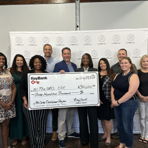 A group of people posing with an oversized check