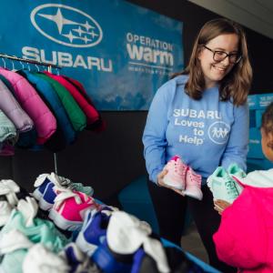 person handing clothes to someone