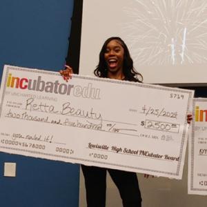 Someone holds an oversized check for Retta Beauty 