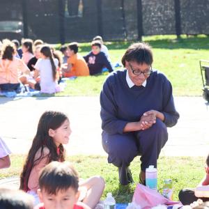 Children sat outside on the grass