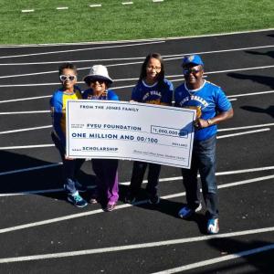 A group of people holding a cheque 
