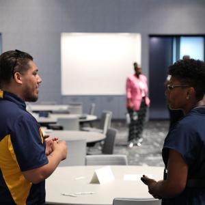 Two people stood opposite each other 