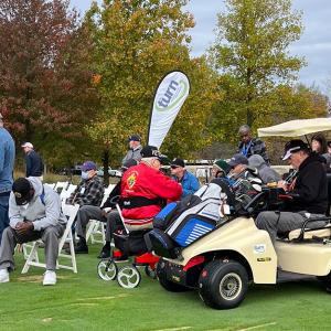 Participants, volunteers, and caregivers at the 2023 Stars, Stripes, and Links Event at Sand Ridge Golf Club in Chardon, Ohio.