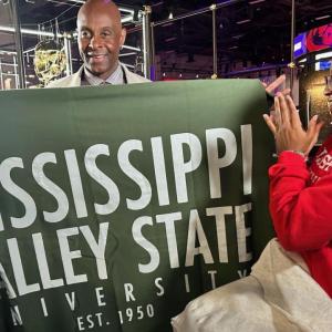 Two people holding a Mississippi Valley State University banner