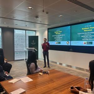 A person stood in front of a room of people