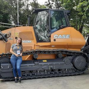 A person leaning against agricultural machinery 