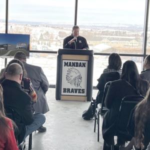 Someone at a podium speaking to a group