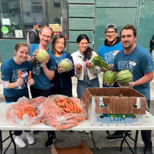 Group holding produce and smiling