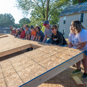 People raising a wall together