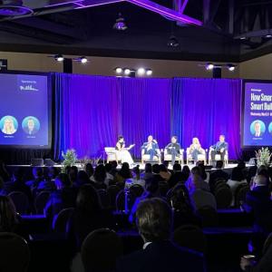 People sat on stage in front of an audience at the 2024 WELL Conference