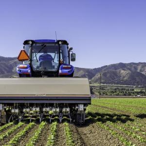 A tractor in a crop field