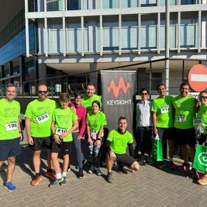 Group photo of employees stood together in front of a Keysight banner