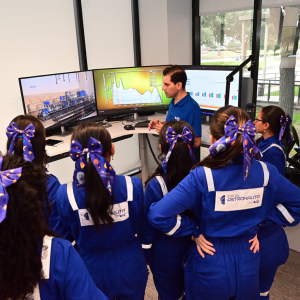 A group of students listening to someone speaking