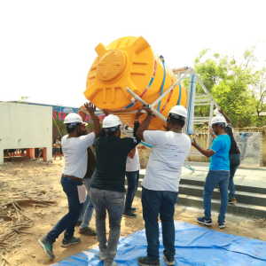 People lifting a large water container onto a platform