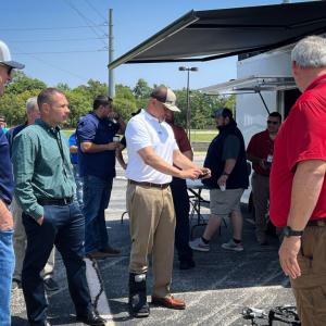 People gathered together around a drone