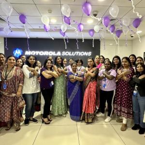 A group posing with balloons above them