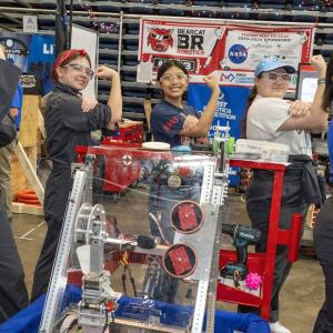People making fists next to robotics