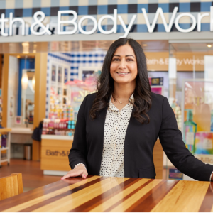 Person standing at a table outside a Bath & Body Works store