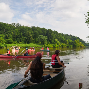 People kayaking down a river