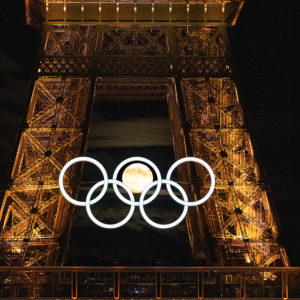 Olympic rings lit up on the side of the Eiffel Tower