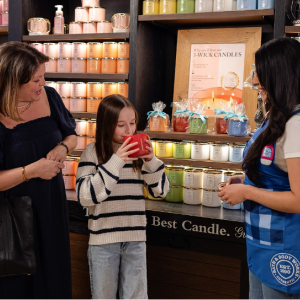 A Bath & Body Works employee helping two customers in a store