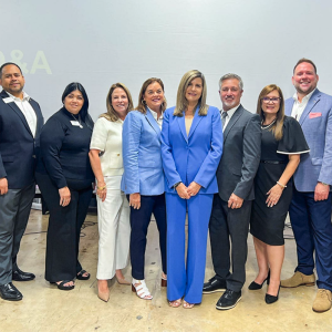 A standing group of people smiling
