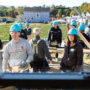 A group of people in blue hard hats working outside