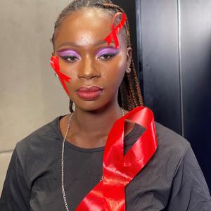 Person with red ribbons on their face and shirt