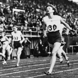 people running a race, crossing the finish line