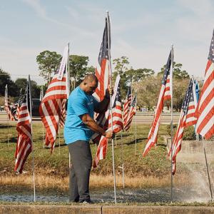 Duke Energy volunteers help place flags at the Field of Honor in Seminole, Fla.