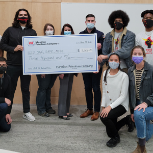 Members of a student organization at University of Utah holding a check from Marathon Petrolium