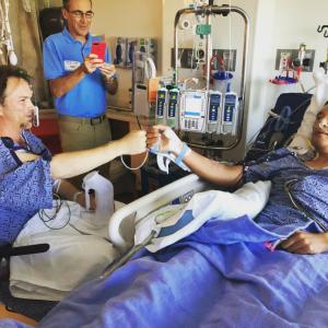 Phil Shin greets longtime friend and liver donor Mark Murphy following their successful transplant surgeries.