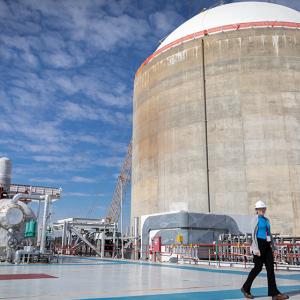 Nicole Flippin walking around outside structures at the power plant