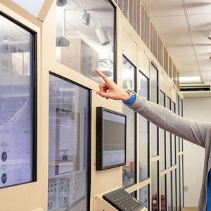 Nicole Flippin pointing at a screen on a wall