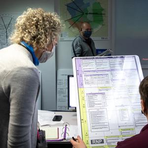 Nicole Flippin looking over a large document with another person