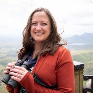 Jennifer McCarthey Tyrrell holding binoculars