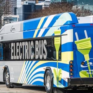 electric buses charging on a city street