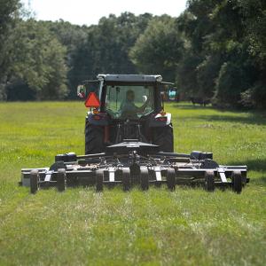 Slade Williams in a tractor on a grassy field