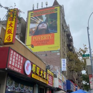 Building with a billboard that reads: Poverty. It's not what you think.